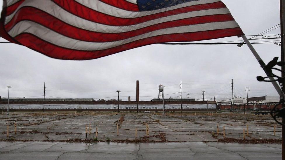 An overgrown parking lot lies empty in front of the closed Packard Electric complex on 29 October, 2012 in Warren, Ohio.