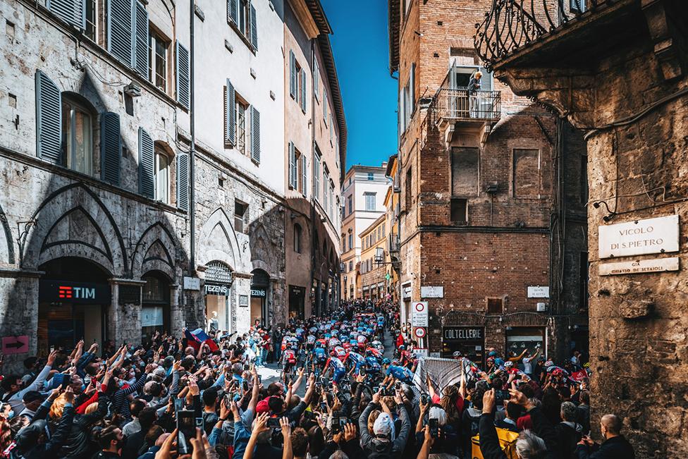 The peloton rides through Siena, Italy, at the start of stage 12 of the 2021 Giro d'Italia