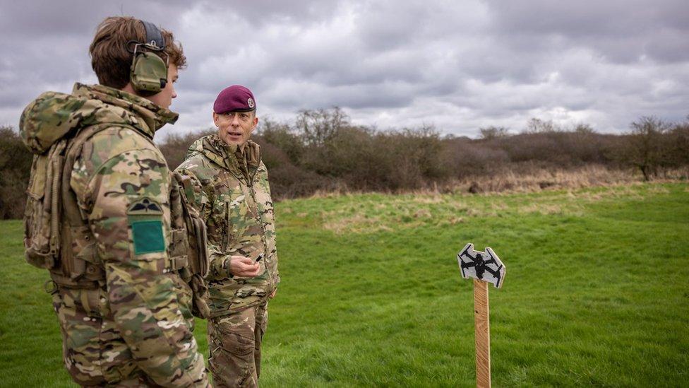 A soldier takes instructions from another