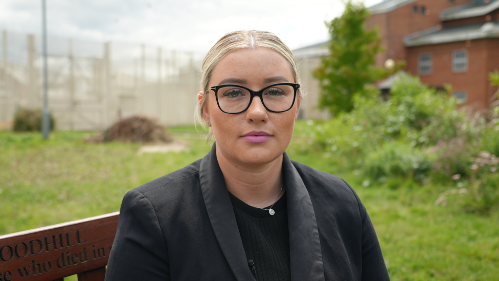 Chelsea Lee sitting on a bench at HMP Woodhill in Milton Keynes.