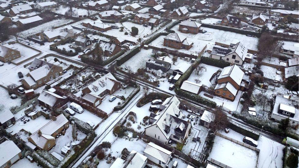 Houses and streets covered in snow