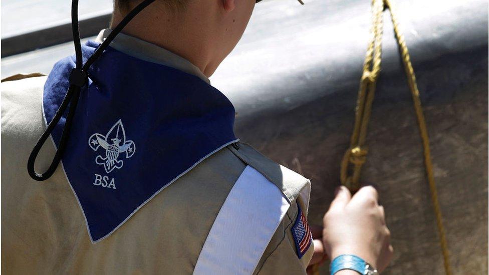 A Boy Scout works on a canoe at camp Maple Dell on July 31, 2015 outside Payson, Utah