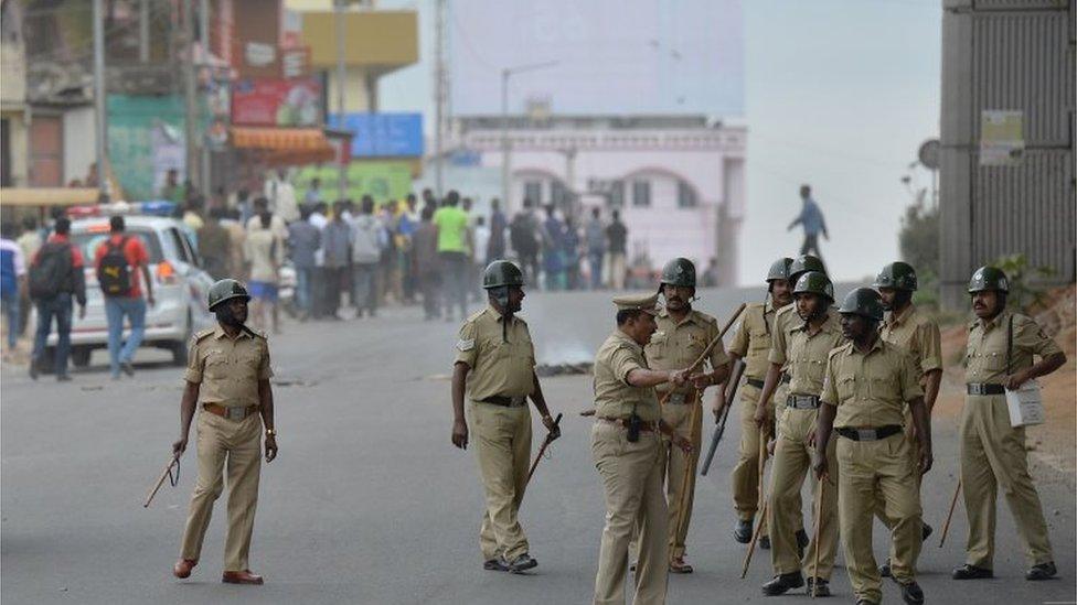 Police personnel chase agitated pro-Karnataka activists as the Cauvery water dispute erupted into violence following the Supreme Court"s order to release water to Tamil Nadu, in Bangalore on September 12, 2016.