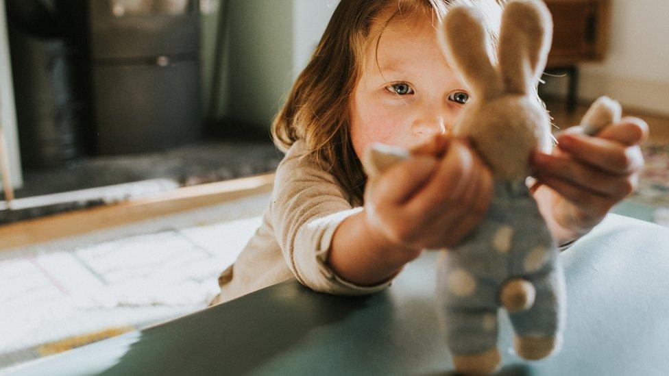 file picture of young child playing with toy