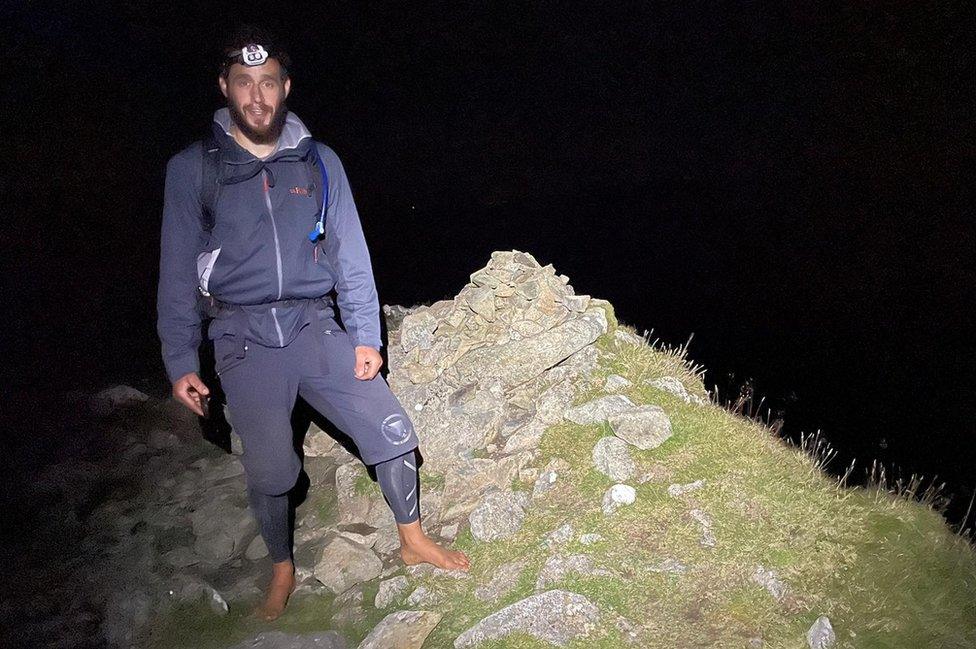 Matt in darkness barefoot on rocks