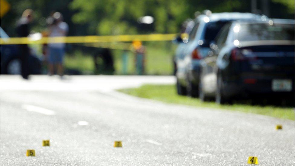 Police evidence markers near the club