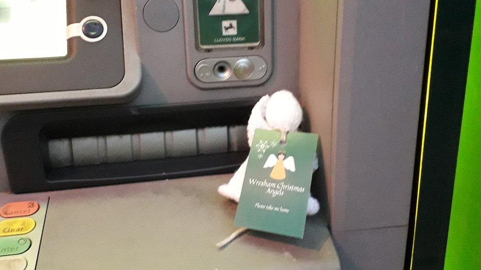 An angel at a cashpoint