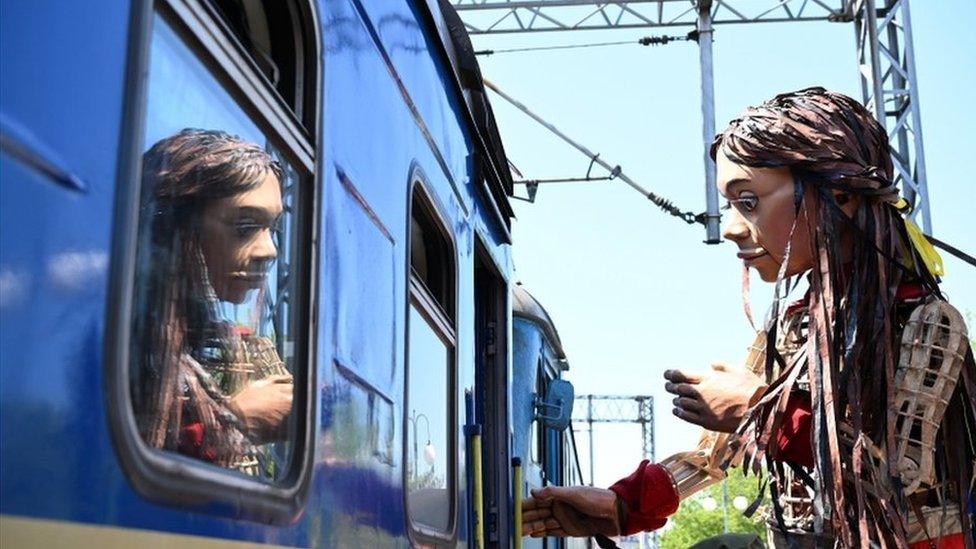 Little Amal at the train station