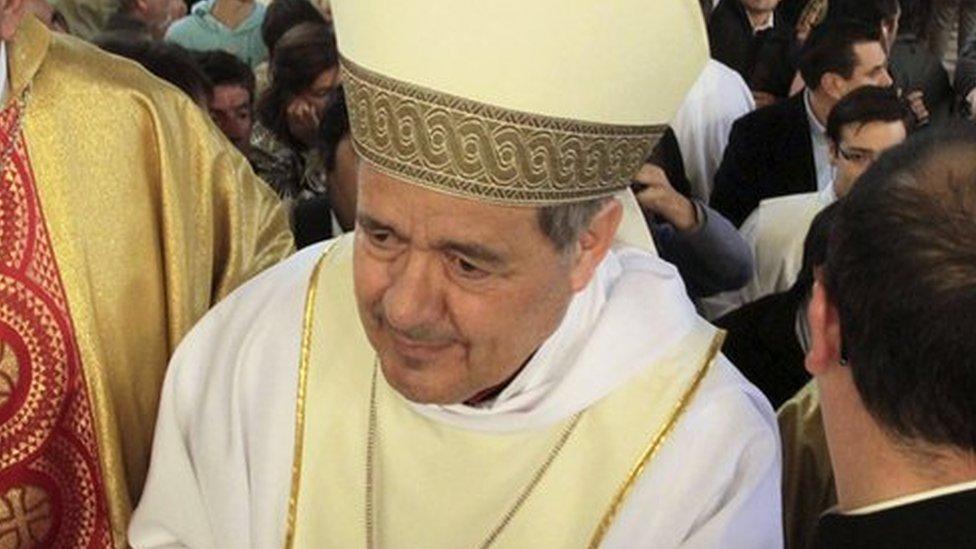 Bishop Juan Barros (C) attends his first religious service as people protest against him at the Osorno cathedral, south of Santiago, Chile, 21 March 2015