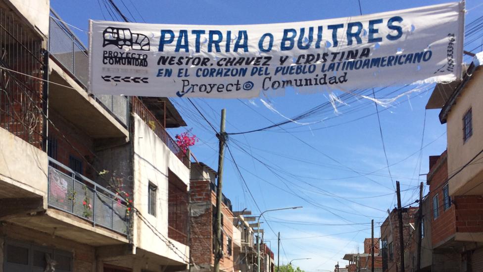 A banner in Villa Soldati reads "Homeland or Vultures. Nestor, Chavez and Cristina in the heart of the Latin American people"