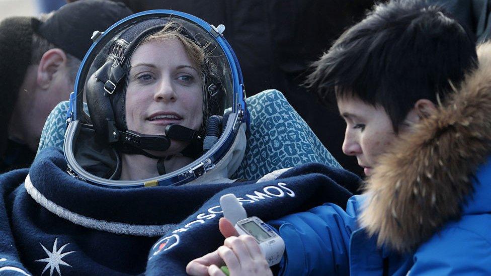 US astronaut Kate Rubins rests in a chair outside the Soyuz MS space capsule after she and two other astronauts landed in a remote area about 150 kms (90 miles) southeast of the Kazakh town of Dzhezkazgan.