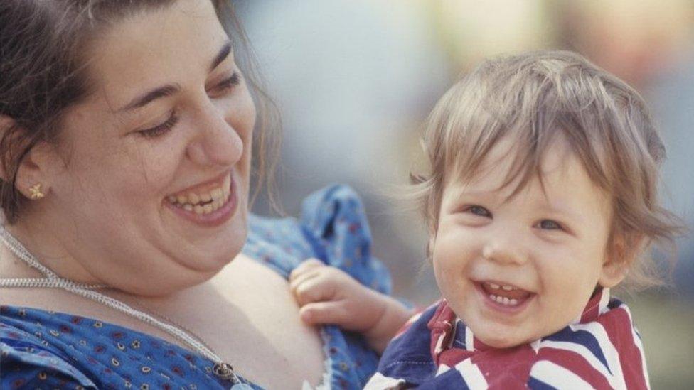 Owen Elliot-Kugell being held by her mum Mama Cass Elliot