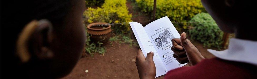 Two pupils read a book in Kenya