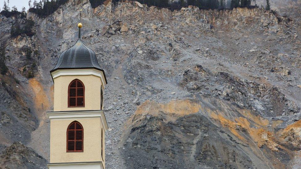 A church in front of the rockslide zone