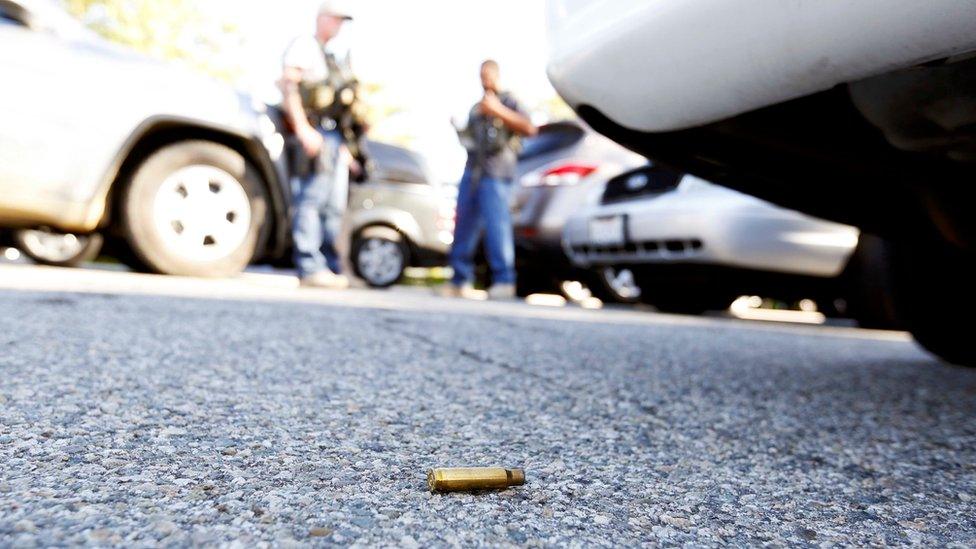 A spent cartridge lies on the ground as police officers secure the area after at least one person opened fire at a social services agency in San Bernardino, California December 2, 2015.