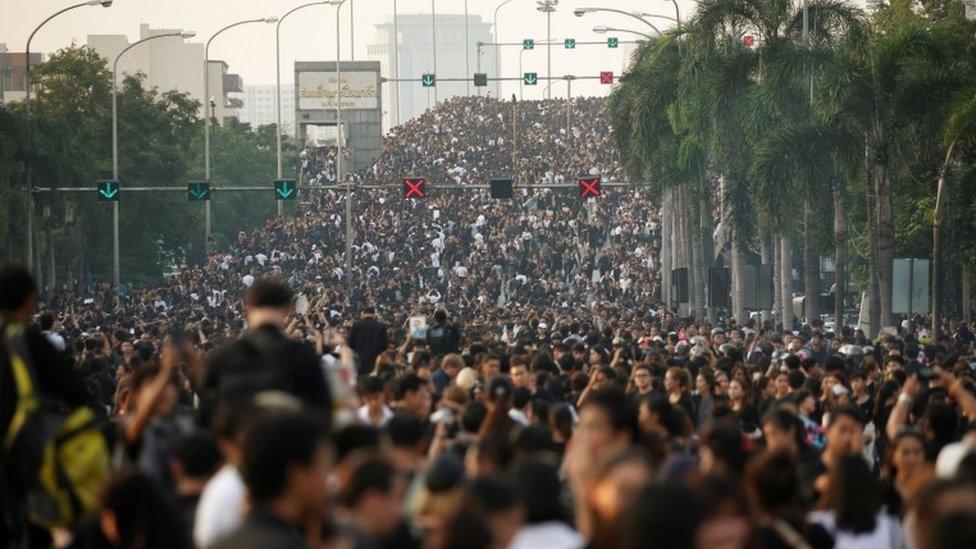 Crowds gather for the Thai king's funeral procession