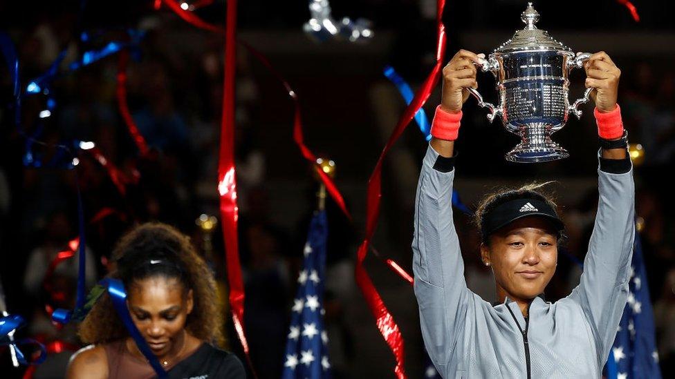 Naomi Osaka of Japan poses with the championship trophy after winning the Women's Singles finals match against Serena Williams of the United States