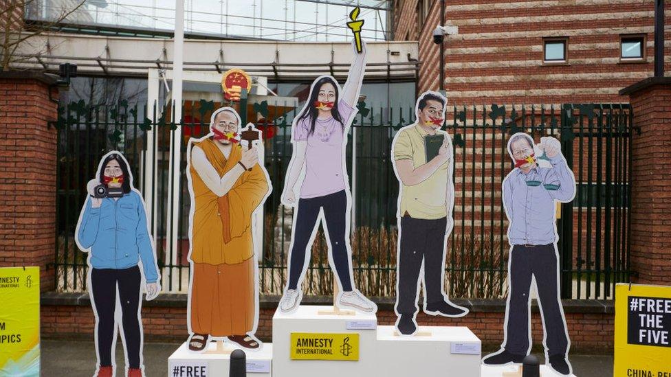 A podium protesting the imprisonment of five Chinese activists, including Li Qiaochu (centre)