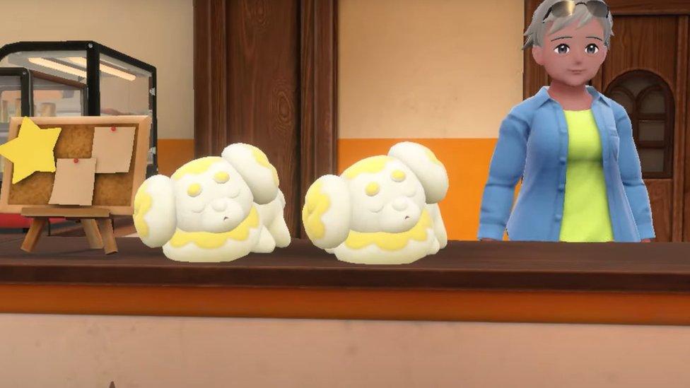 screengrab from footage of the pokemon violet and scarlet game featuring the new pokemon fidough asleep on a shop counter