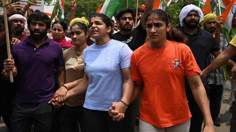 Indian wrestlers Bajrang Punia (L), Vinesh Phogat (2nd L), Sakshi Malik (2nd R) and Sangeeta Phogat (L) attempt to march to India's new parliament, just as it was being inaugurated by Prime Minister Narendra Modi.