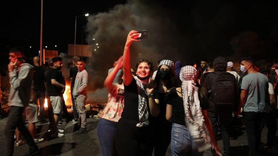 Palestinian protesters take a selfie, May 2021