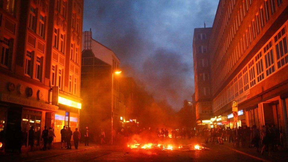 Barricades burn as protesters clash with riot police during the protests at the G20 summit in Hamburg, Germany, July 7, 2017.