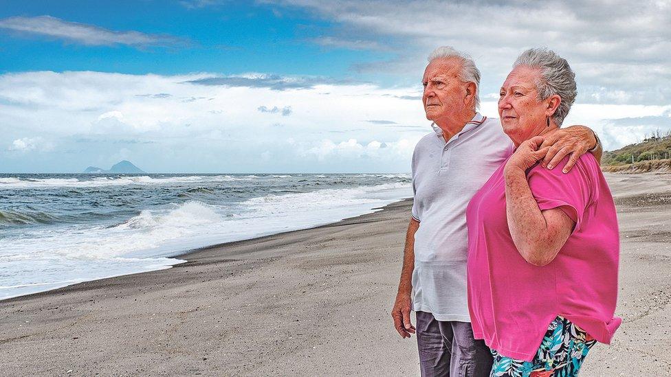 Hero fisherman Gus Hutt with his wife Sue where he saved the baby's life at Matata Beach