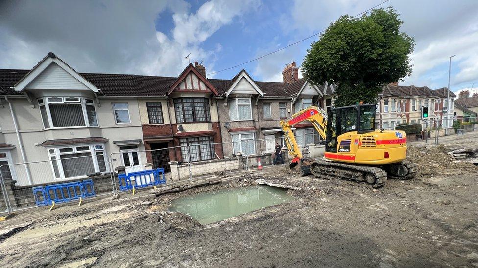 A digger and work going on at the County Road