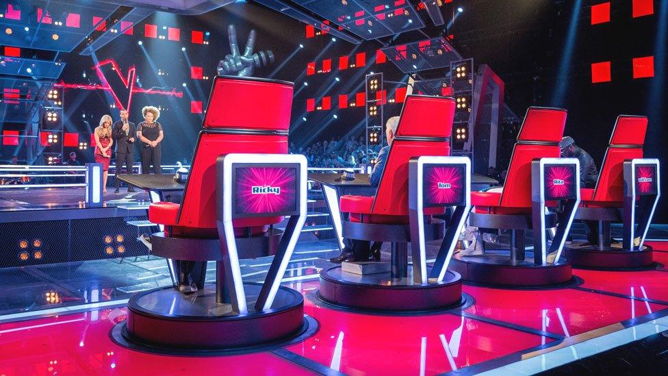 The Voice Coaches behind their chairs