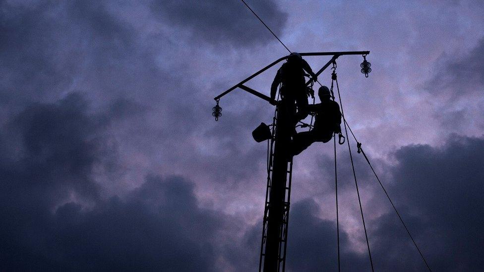 Workmen repairing power lines