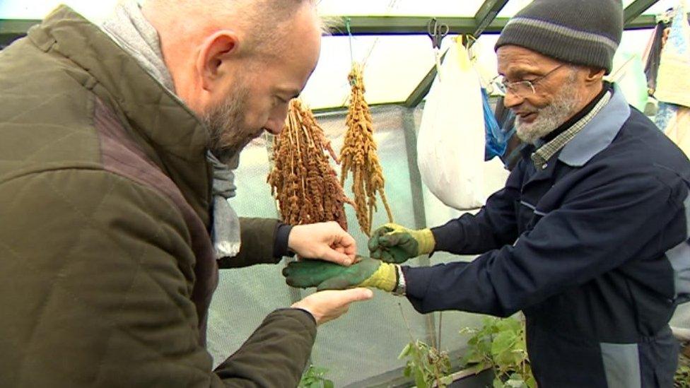 David Gregory-Kumar being handed some seeds