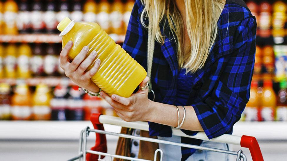 Woman holding orange juice