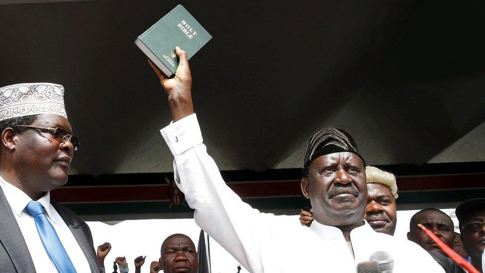 Raila Odinga at his "inauguration", holding the bible in the air