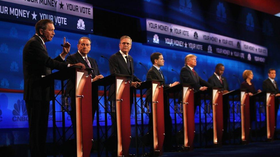 Republican candidates watch John Kasich speak at the debate in Colorado.