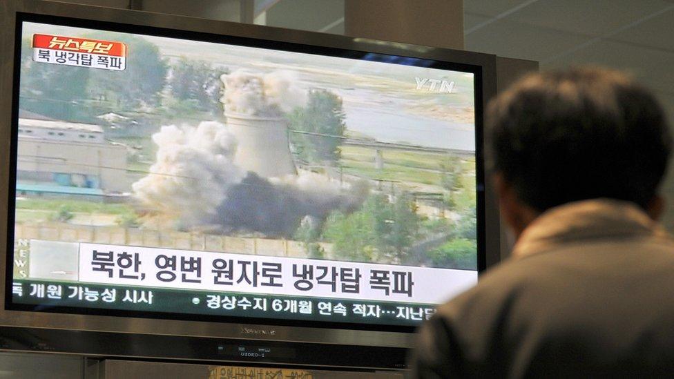 A South Korean looks at footage of the demolition of North Korea's cooling tower at its Yongbyon nuclear complex