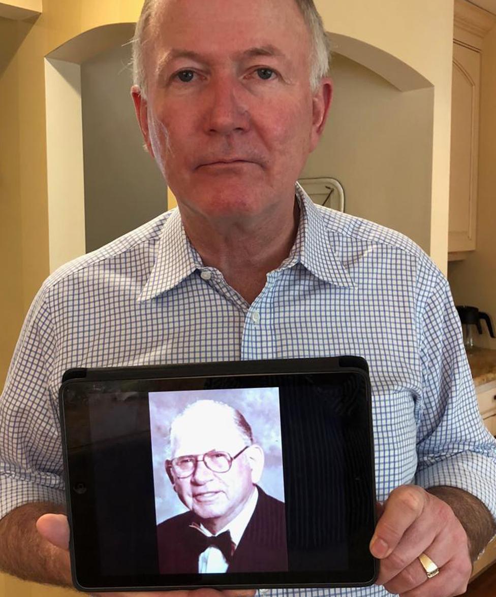 Bill Griffeth holding a picture of his biological father