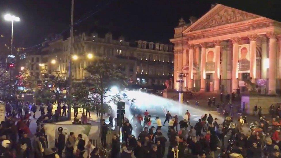 police using water cannon on a crowd