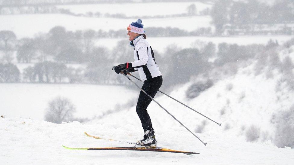 A skier makes their way through the snow in Wye National Nature Reserve near Ashford in Kent on Sunday