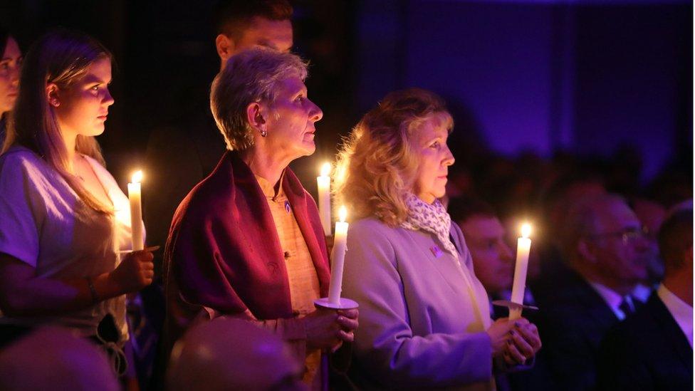 People hold candles during the UK Holocaust Memorial Day Commemorative Ceremony at Central Hall in Westminster, London