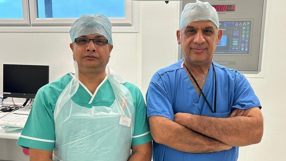 Two male doctors wearing medical scrubs