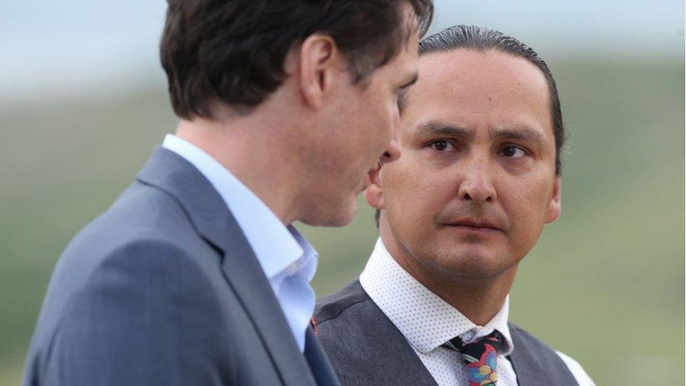 Prime Minister Justin Trudeau (L) speaks to Chief Cadmus Delorme during a visit to Cowessess First Nation