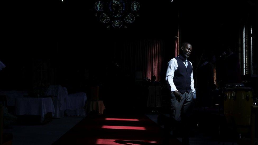 Worshippers pray during a service at the God"s Church of Peace in London