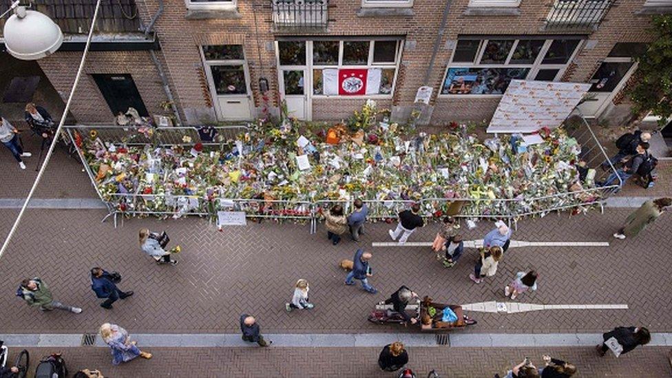 People lay flowers for murdered Dutch crime journalist Peter R de Vries