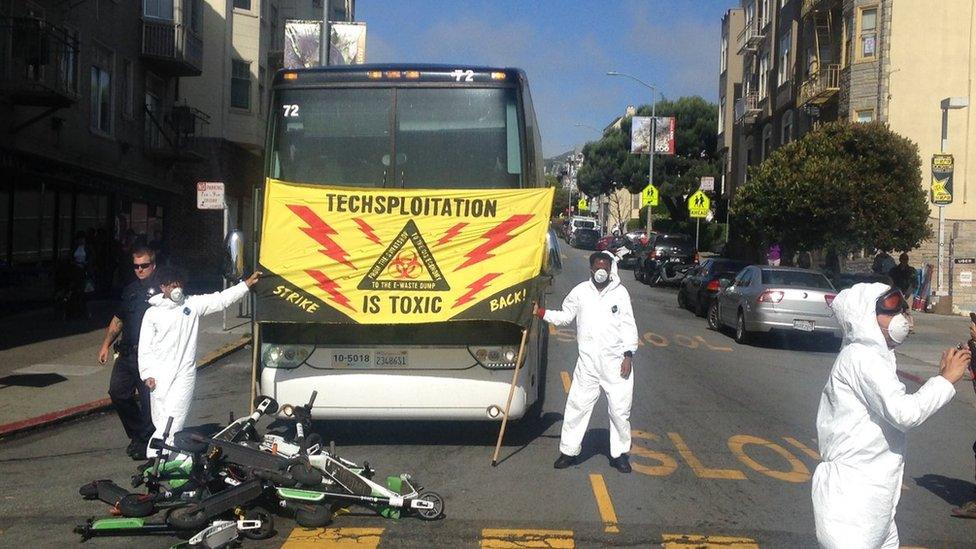 Protesters stacked electric scooters in the buses path