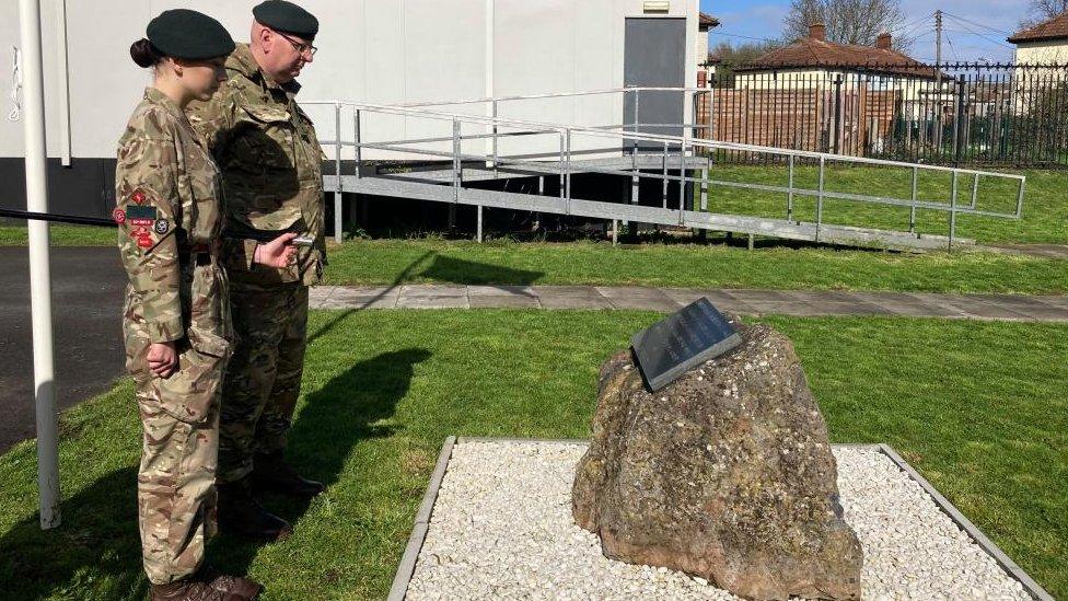 Two cadet members next to Andrew Barr's plaque