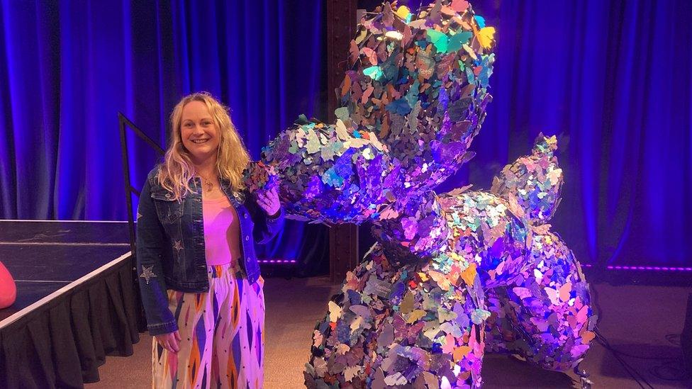 Artist Caroline Parrott standing next to her creation "Papillon" which was voted "Top Dog" by the public