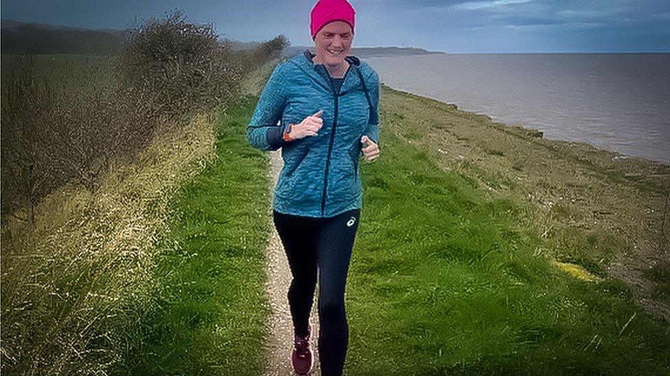 Gayle Redman running along a seaside trail