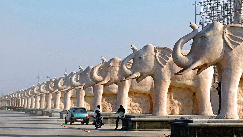 A row of stone elephants at a park in Uttar Pradesh.