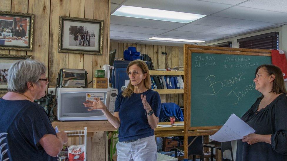 Rachel Lapierre (centre) with her sister Guylaine (right) and a volunteer discuss their plans in Le Book Humanitaire’s office