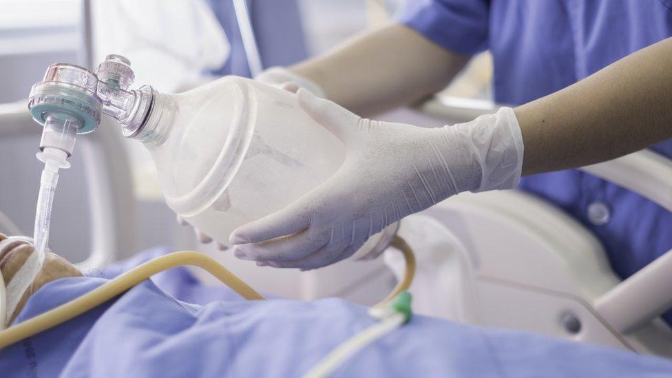 Medical staff administering oxygen to a patient